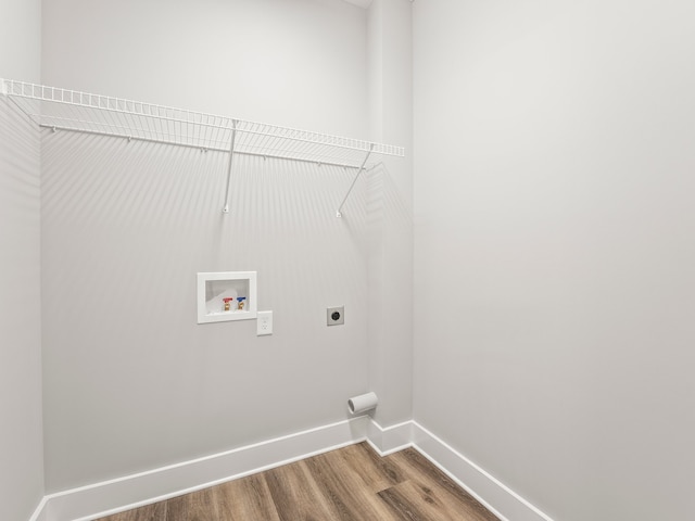 washroom with washer hookup, hookup for an electric dryer, and hardwood / wood-style floors