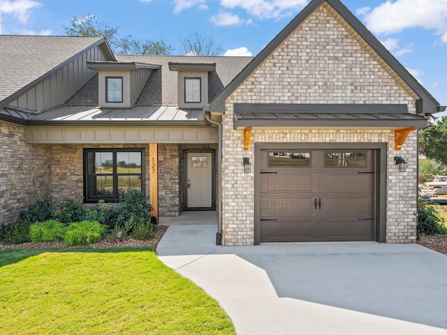 view of front of home with a garage and a front yard