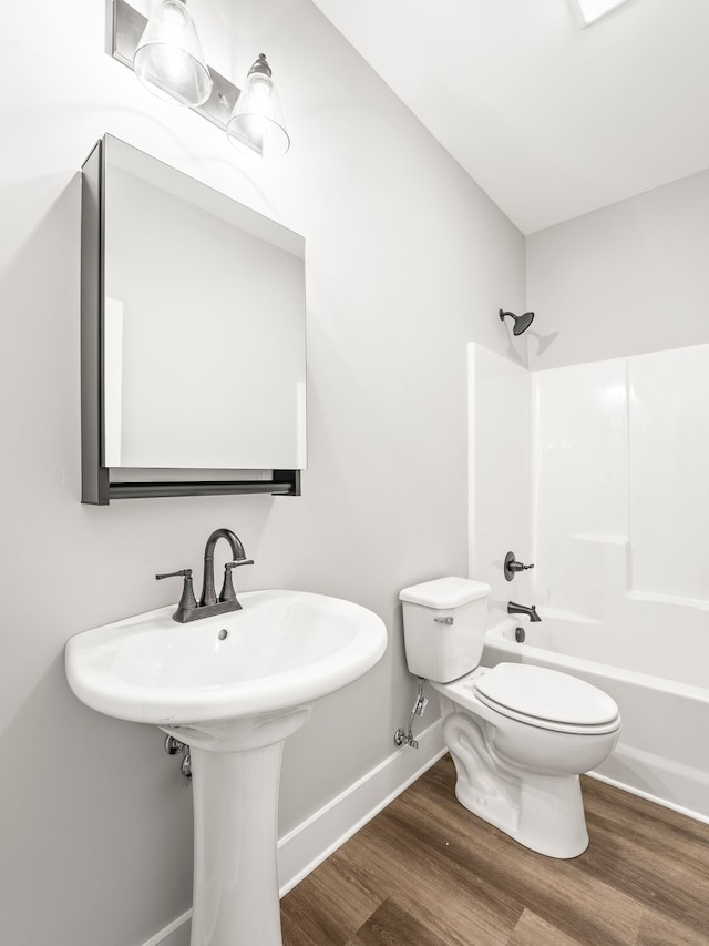 bathroom with wood-type flooring,  shower combination, and toilet