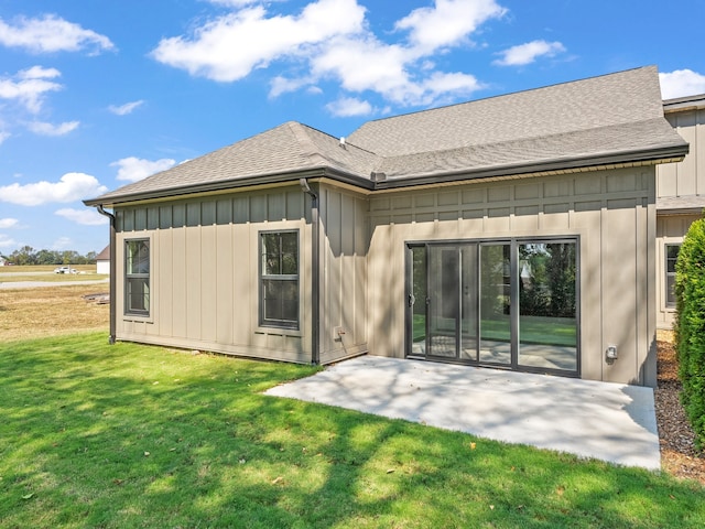 back of property featuring a yard and a patio