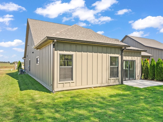 back of property with a lawn, a patio, and central air condition unit