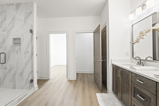 bathroom featuring vanity, hardwood / wood-style floors, and a shower with shower door