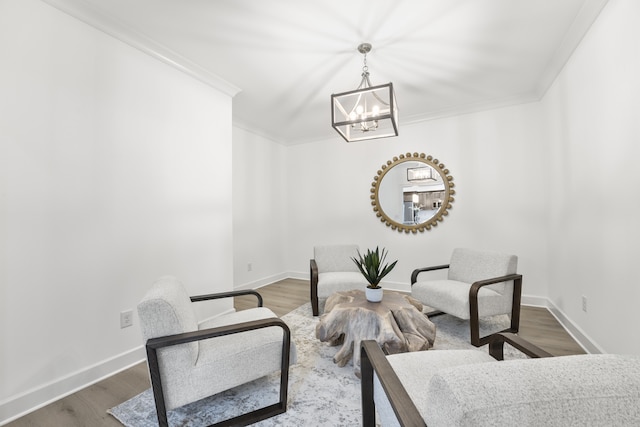 interior space with a notable chandelier, hardwood / wood-style flooring, and crown molding