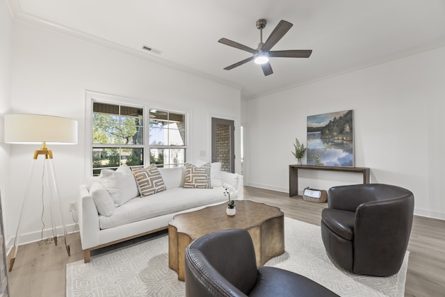 living room featuring ornamental molding, ceiling fan, and hardwood / wood-style flooring