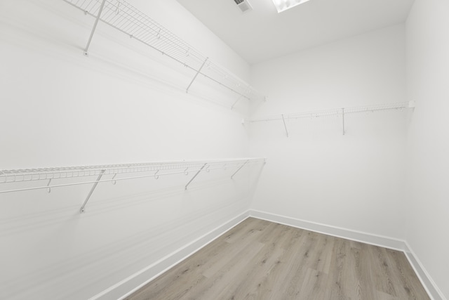 spacious closet featuring light hardwood / wood-style floors