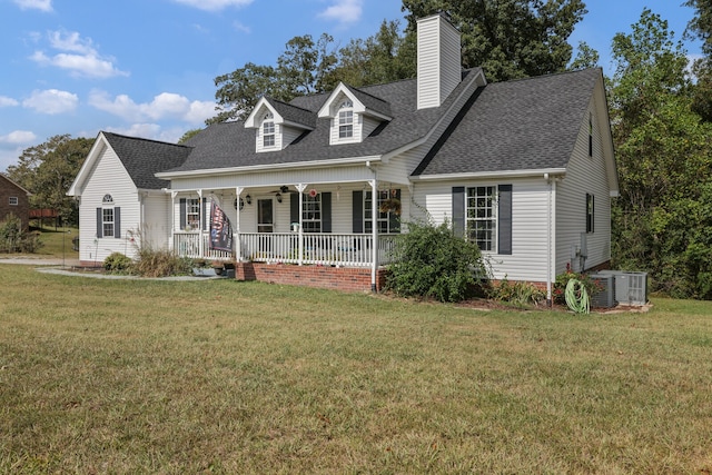 new england style home featuring a front yard and covered porch