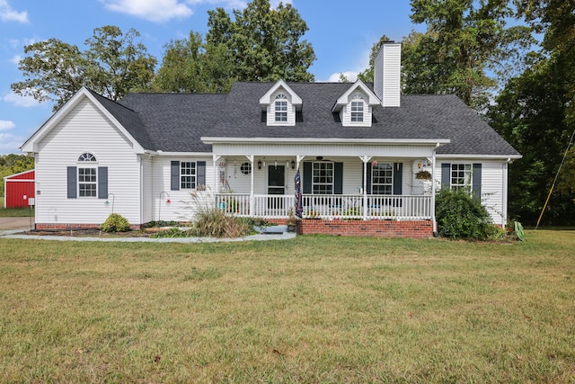 new england style home with a front lawn and covered porch