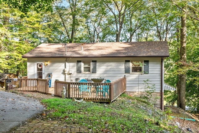 rear view of house featuring a deck