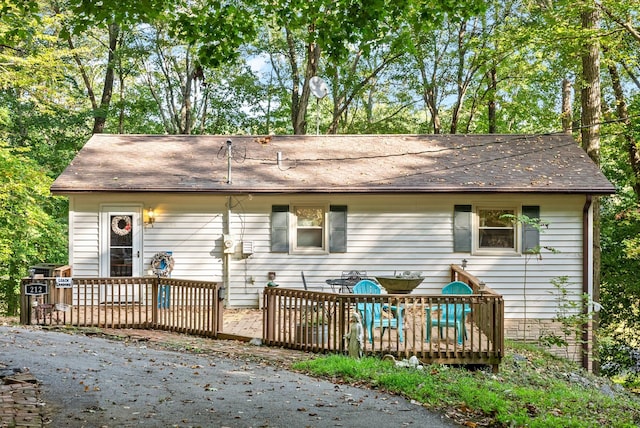 rear view of house featuring a deck