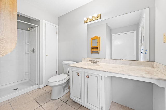 bathroom with vanity, a shower, tile patterned flooring, and toilet