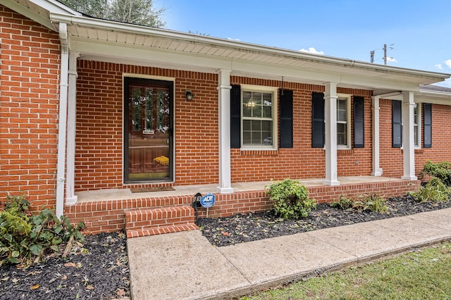 view of exterior entry with covered porch