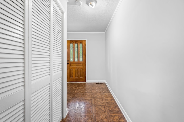 hallway featuring a textured ceiling, ornamental molding, and dark parquet floors