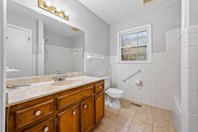 full bathroom featuring tile walls, tile patterned flooring, vanity, and toilet