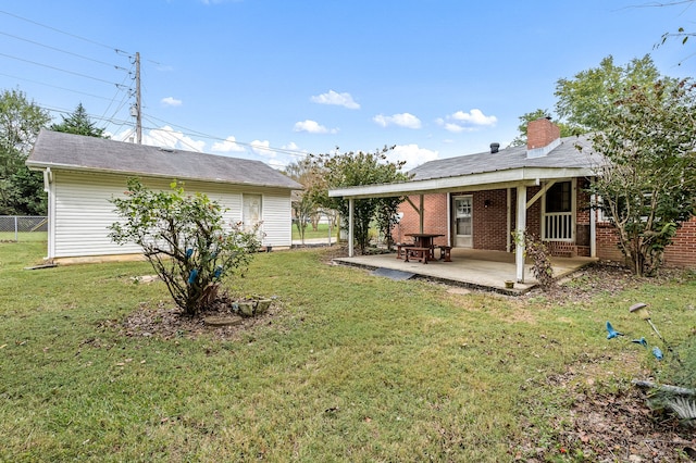 back of house featuring a lawn and a patio