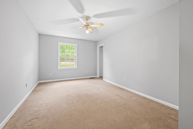 empty room featuring light carpet and ceiling fan