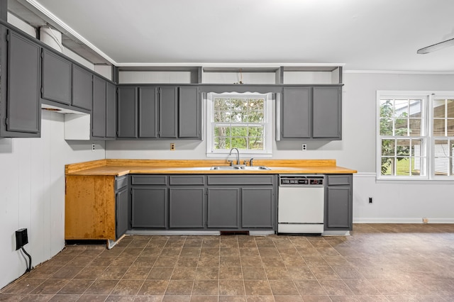 kitchen with gray cabinetry, white dishwasher, and wooden counters