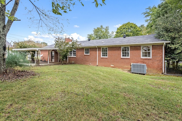 rear view of house with cooling unit, a yard, and a patio