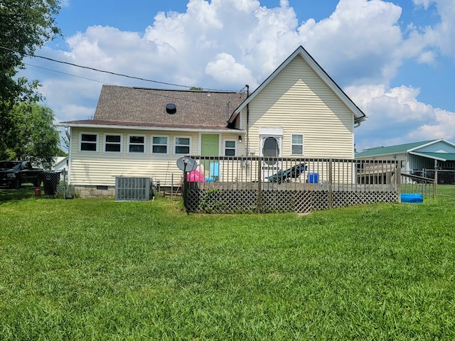 rear view of property with a deck, a lawn, and central air condition unit