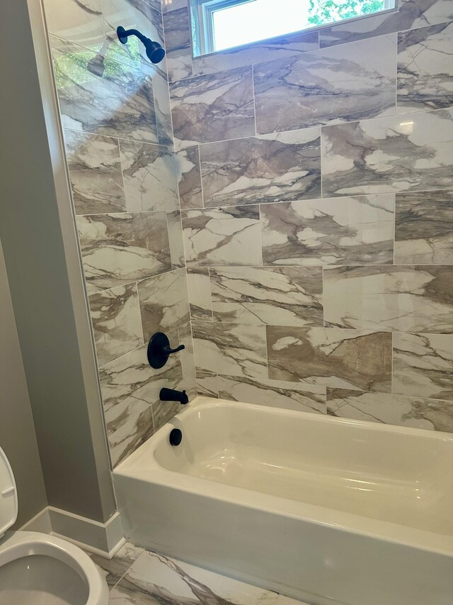 bathroom with toilet and shower / tub combination