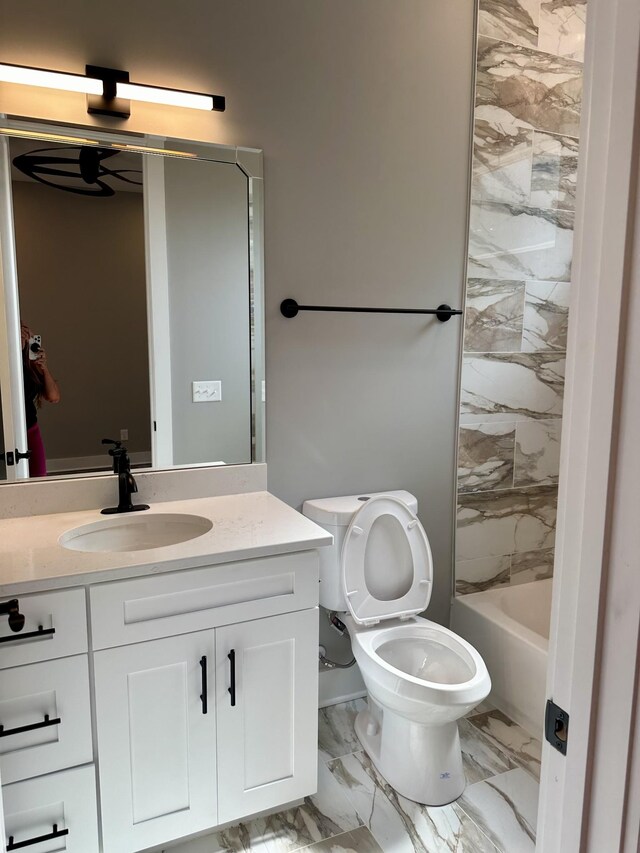 full bathroom featuring toilet, vanity, and tiled shower / bath combo