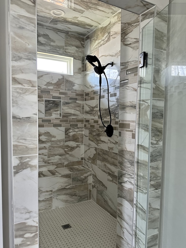 bathroom with tiled shower