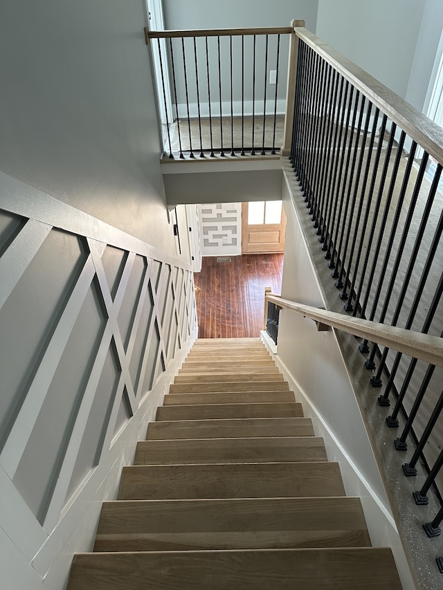 staircase with wood-type flooring