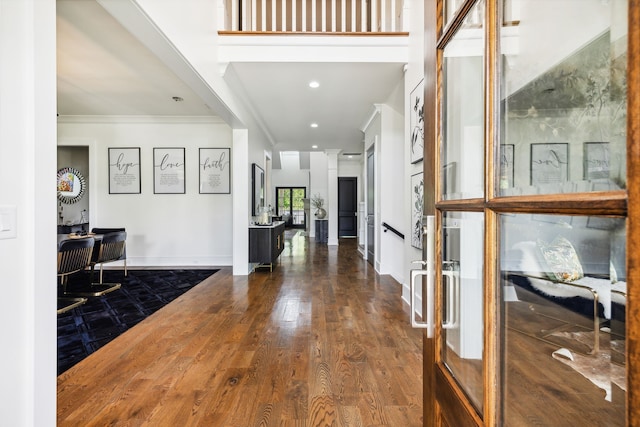 entryway featuring hardwood / wood-style flooring and ornamental molding