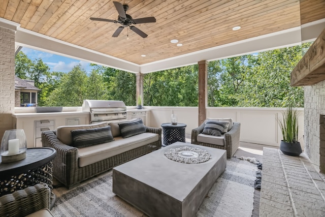 view of patio / terrace featuring ceiling fan, area for grilling, an outdoor hangout area, and an outdoor kitchen