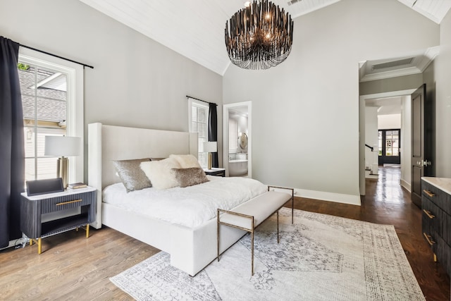 bedroom with a notable chandelier, wood-type flooring, high vaulted ceiling, and multiple windows