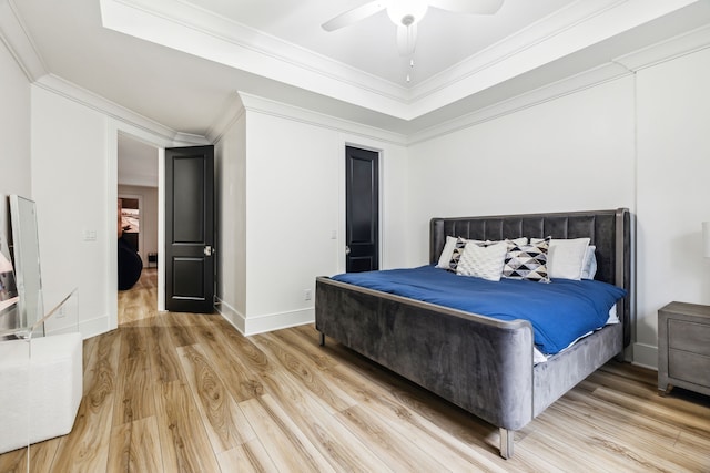 bedroom with ceiling fan, wood-type flooring, and ornamental molding