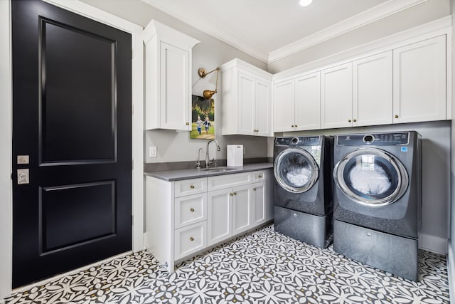 laundry area featuring cabinets, crown molding, sink, independent washer and dryer, and light tile patterned floors