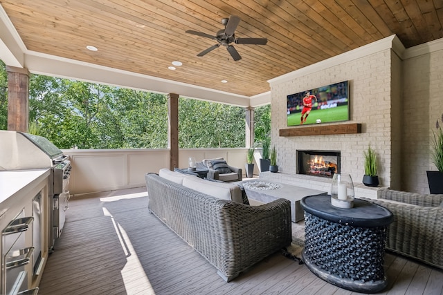 deck with an outdoor living space with a fireplace, a grill, and ceiling fan