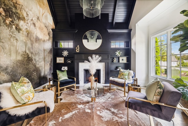 living room featuring a high end fireplace, vaulted ceiling with beams, an inviting chandelier, and wood ceiling