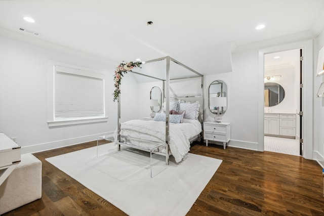 bedroom with ensuite bathroom, crown molding, and dark wood-type flooring