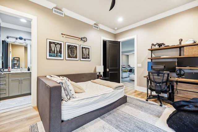 bedroom with ensuite bathroom, light hardwood / wood-style floors, crown molding, and ceiling fan