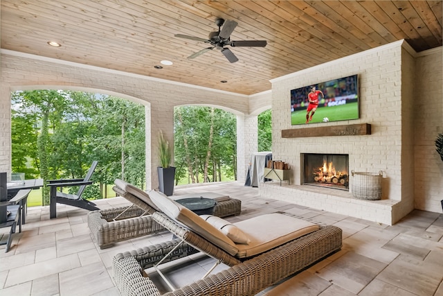 view of patio / terrace with an outdoor brick fireplace and ceiling fan