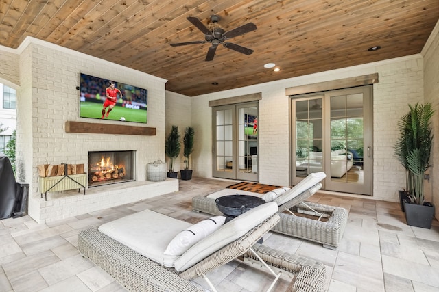 view of patio featuring ceiling fan and an outdoor brick fireplace