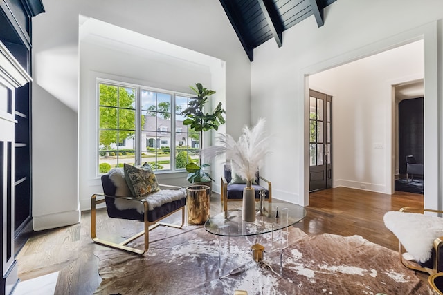 living area featuring beam ceiling, dark hardwood / wood-style floors, high vaulted ceiling, and wooden ceiling