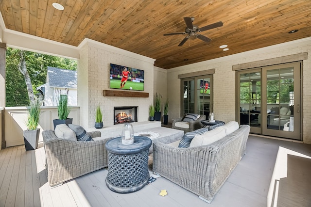 living room featuring wood-type flooring, an outdoor brick fireplace, ceiling fan, and wooden ceiling