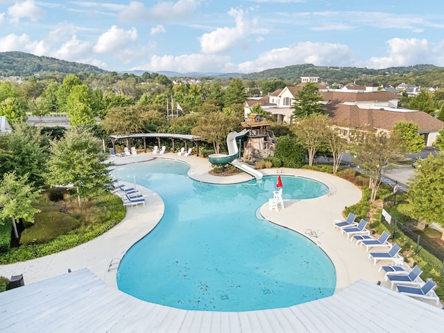 view of swimming pool featuring a mountain view and a water slide