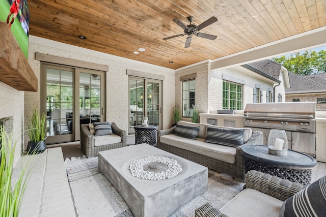 view of patio / terrace featuring ceiling fan, a grill, exterior kitchen, and an outdoor hangout area