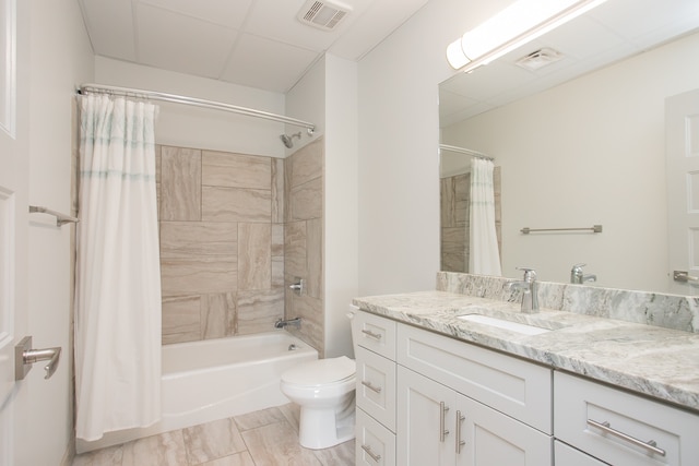 full bathroom featuring shower / bath combo, vanity, and toilet