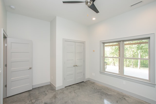 unfurnished bedroom featuring ceiling fan and a closet