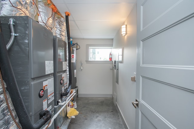 utility room featuring water heater and heating unit