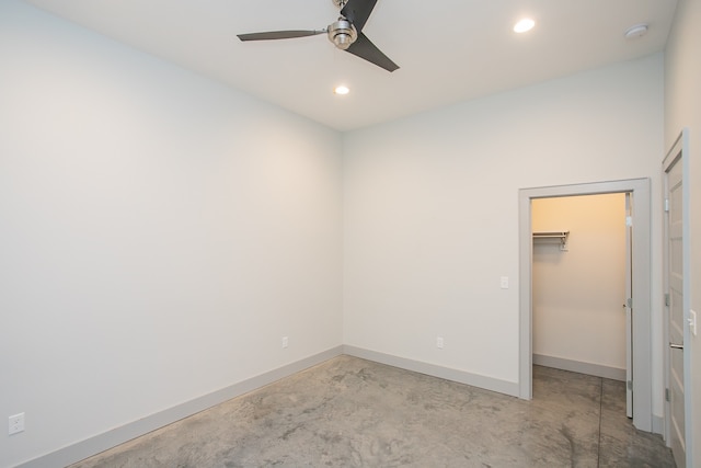 unfurnished bedroom featuring a spacious closet, ceiling fan, and a closet