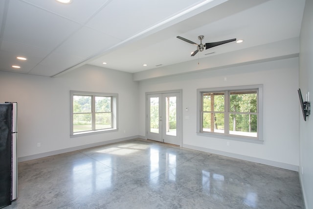 spare room featuring ceiling fan and plenty of natural light