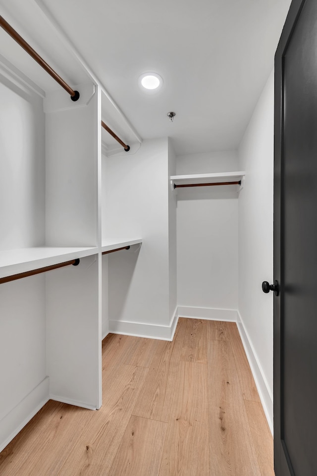 spacious closet with light hardwood / wood-style flooring