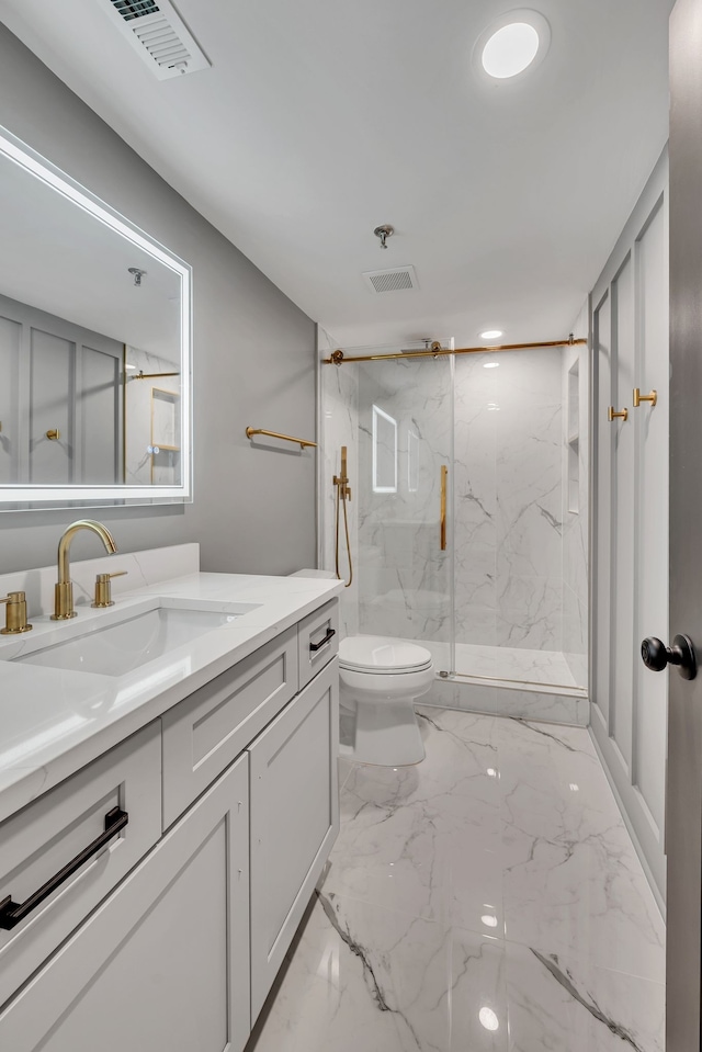 bathroom featuring vanity, toilet, and a shower with door