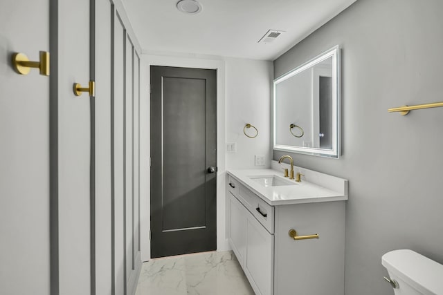 bathroom featuring vanity and toilet