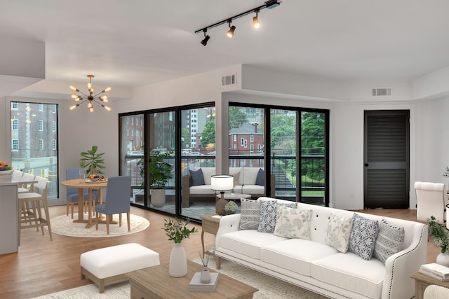 living room with a notable chandelier and wood-type flooring